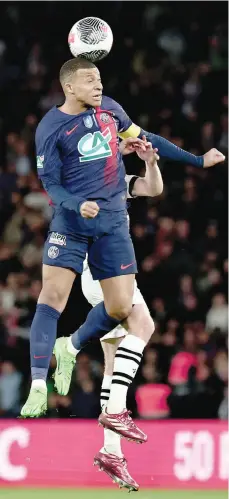  ?? — AFP ?? Paris Saint-germain’s French forward Kylian Mbappe heads the ball during the French Cup semifinal against Stade Rennais FC at the Parc des Princes stadium in Paris on Wednesday.