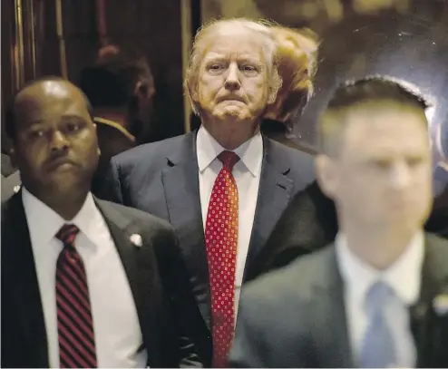  ?? TIMOTHY A. CLARY / AFP / GETTY IMAGES ?? U. S. president- elect Donald Trump stands in the elevator at Trump Tower in New York on Monday.