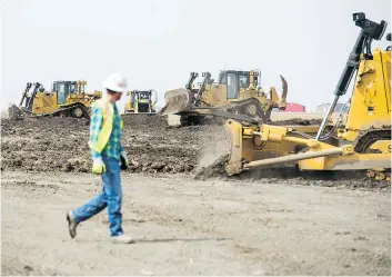  ?? BRANDON HARDER ?? Bulldozers work on a pipeline right-of-way that will eventually be the site of an Enbridge pipeline replacemen­t project to carry heavy crude to refineries in the U.S.