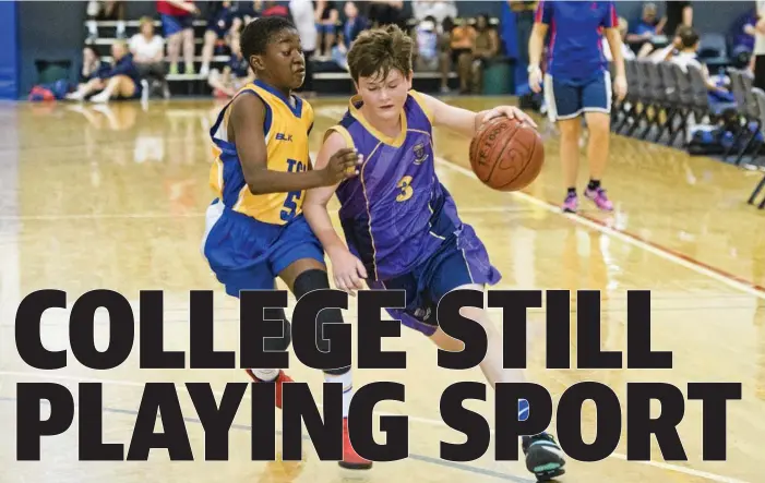  ?? Photo: Nev Madsen ?? ON COURT: St Joseph’s College players James Nugent (right) drives to the key during his side’s Friday Night Basketball Competitio­n match against Toowoomba Grammar School.