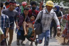  ?? THE ASSOCIATED PRESS ?? Anti-coup protesters carry an injured man following clashes with security in Yangon, Myanmar.