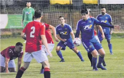  ??  ?? ● John Keatley on the ball for Skem