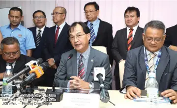  ??  ?? Baru (centre, seated) speaks at the press conference after a briefing at the state JKR office. — Photo by Chimon Upon