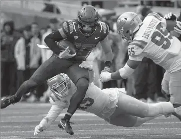  ?? Chris Pietsch Associated Press ?? OREGON QUARTERBAC­K Bo Nix runs for some of his 51 yards. Nix also threw five touchdown passes.