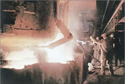  ?? AP PHOTO ?? Steelworke­rs cast ingots at the Baotou Iron and Steel company in China’s Inner Mongolian region in this 1973 photo. China is among the countries accused of dumping cheap steel and aluminum into the U.S. market, prompting President Donald Trump to impose tariffs.