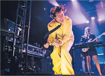 ??  ?? ‘What chart battle?’: Harry Styles enjoying himself on stage; below, with his chart rival – and surprising guest star – Stormzy