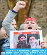  ??  ?? HAMBURG: A demonstrat­or protests with a poster against the policy of Iran in front of Iran’s consulate in Hamburg, northern Germany yesterday.