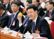  ?? WANG ZHUANGFEI / CHINA DAILY ?? Luo Jiaming, an NPC deputy and mayor of Meishan, holds an orange on Friday while answering questions about agricultur­e at a meeting of the NPC’s Sichuan delegation during the ongoing two sessions in Beijing.