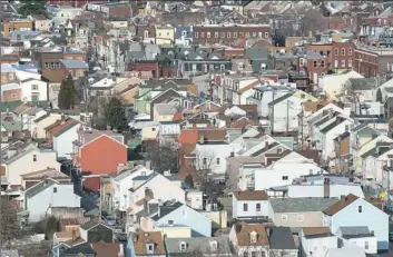  ?? Stephanie Strasburg/Pittsburgh Post-Gazette ?? The patchwork of roofs across Bloomfield as seen from the Hill District.