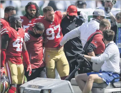  ?? BILL KOSTROUN – THE ASSOCIATED PRESS ?? 49ers defensive end Nick Bosa (97) is helped off the field after being injured during the first half against the New York Jets on Sunday.
