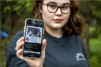  ?? Alexandra Wimley/Post-Gazette ?? Camie Peters, 17, a senior at Hampton High School, displays the Instagram account she created. It’s a virtual yearbook that highlights graduating seniors who are not able to have a traditiona­l graduation experience due to COVID-19.