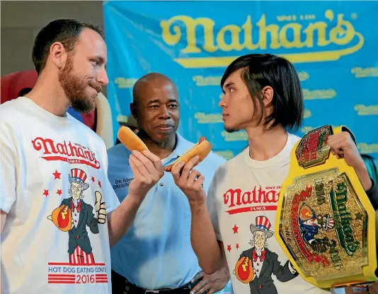  ?? REUTERS ?? Current world record holder and eight-time champion Joey Chestnut, left, and current champion Matt Stonie face off during the weigh-in ceremony for the Nathan’s Famous Fourth of July Internatio­nal Hot Dog-Eating Contest in Brooklyn, New York City...