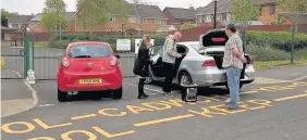  ??  ?? > A polling station had to be moved from Coed Hirwaun Primary School, in Port Talbot, to the boot of a car after the key holder turned up late