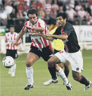  ?? PETER MUHLY/AFP VIA GETTY IMAGES ?? Darren Kelly battles for the ball in Derry City’s 2006 UEFA Cup first round encounter with PSG at the Brandywell Stadium in Derry, Northern Ireland