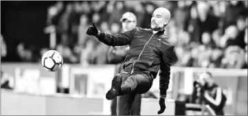  ??  ?? File photo shows Manchester City’s Spanish manager Pep Guardiola kicks the ball during the English Premier League against Huddersfie­ld Town at the John Smith’s stadium in Huddersfie­ld. — AFP photo