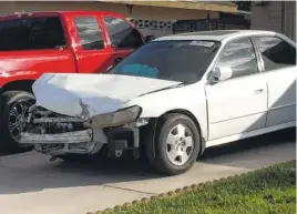  ?? THE ASSOCIATED PRESS ?? A white 2002 Honda Accord involved in a crash in which an exploding Takata air bag inflator badly injured the driver, Karina Dorado, sits in a driveway in Las Vegas. The incident has exposed a danger posed by the recalled parts. Nothing prevents the...