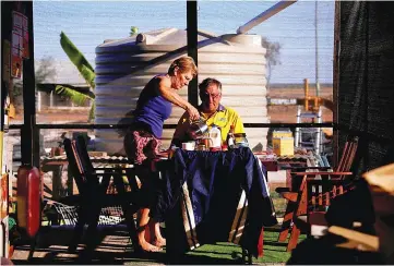  ??  ?? Local residents Judy and Baldry prepare to eat breakfast at their property, in the outback town of Stonehenge on Aug 13.