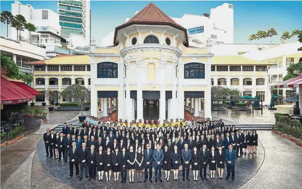  ??  ?? Dato’ Seri Khor Teng Tong (front row, 10th left) posing with the big Hunza family at Gurney Paragon which is owned and managed by the Hunza Group. Khor sees every member of the team as integral to Hunza Group’s success.