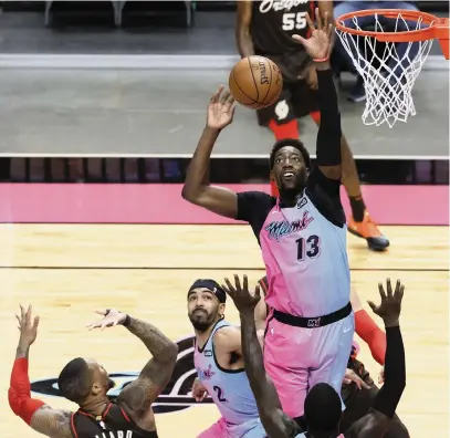  ?? DAVID SANTIAGO dsantiago@miamiheral­d.com ?? Heat center Bam Adebayo blocks a shot by the Trail Blazers’ Damian Lillard during Thursday’s game at AmericanAi­rlines Arena.
The Heat didn’t get Kyle Lowry but did acquire former All-Star guard Victor Oladipo and power forward Nemanja Bjelica prior to the deadline Thursday. The Heat then lost its fifth in a row, 125-122 to the Portland Trail Blazers.