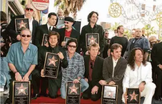  ?? Jeffrey Mayer/WireImage 2005 ?? George Tickner (back left) is recognized with other former and current Journey members as the band receives a star on the Hollywood Walk of Fame.