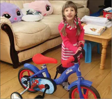  ??  ?? Six-year-old Ana Nistor with her bicycle.