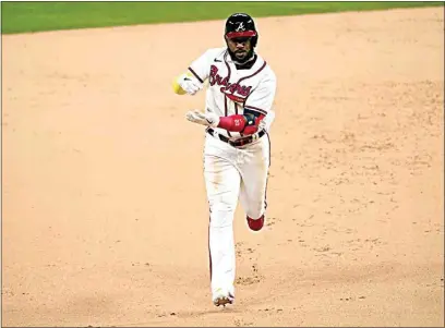  ?? TONY GUTIERREZ / AP ?? The Braves’ Marcell Ozuna celebrates a home run against the Dodgers during the seventh inning in Game 4 of the MLB National League Championsh­ip Series on Thursday in Arlington, Texas.