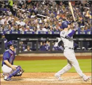  ?? Julie Jacobson / Associated Press ?? The Dodgers’ Cody Bellinger, right, follows through on a grand slam against the Mets on Friday.