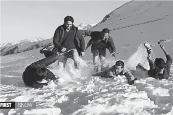  ?? — PTI ?? Tourists play with snow after the season’s first snowfall at Peer Ki Gali, in Jammu and Kashmir’s Shopian district, on Monday.