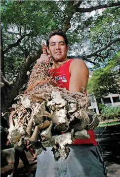  ?? [AP FILE PHOTO] ?? Kamalei Grady holds a large kava plant root in 2006 at the Kava Festival in Honolulu.