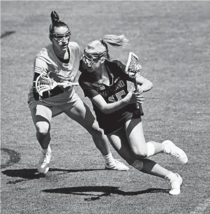  ?? KIM HAIRSTON/BALTIMORE SUN ?? Maryland attacker Aurora Cordingley moves the ball against Johns Hopkins’ Jeanne Kachris during the first half of a Big Ten game April 2. The topseeded Terps will face the Blue Jays or Duke on Sunday.