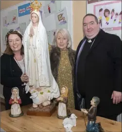  ??  ?? Rita Waters, principal, Mary Prunty and Fr Aodhan Marken celebrate Mary’s 40 years of service to Our Lady of Fatima School. Mary, on behalf of the school, accepted statues of ‘Our Lady of Fatima with Children’ from Fr Aodhán Marken, who was following the wishes of a parishione­r.