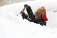  ?? AP PHOTO/JOSHUA BESSEX ?? Zaria Black, 24, clears off her car Friday during heavy snowfall in Buffalo, N.Y.