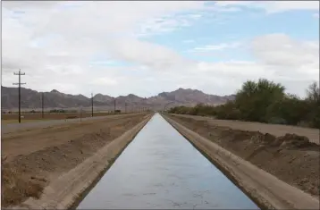  ?? PHOTO COURTESY OF GREATERYUM­A.ORG ?? DIRT AGRICULTUR­E CANALS LIKE THIS reasons, including food safety. one are becoming less common in Yuma County. Dirt ditches are being lined for many