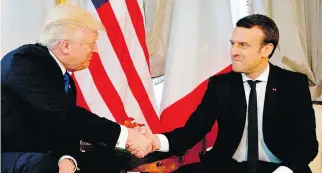  ?? PETER DEJONG/AFP/GETTY IMAGES ?? U.S. President Donald Trump shakes hands with French President Emmanuel Macron in Brussels. The French leader beat the U.S. president in a white-knuckle squeeze session, Josh Freed writes.