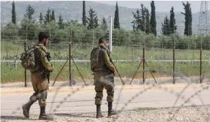  ?? (Flash90) ?? IDF SOLDIERS stand guard near a hole in the security fence.