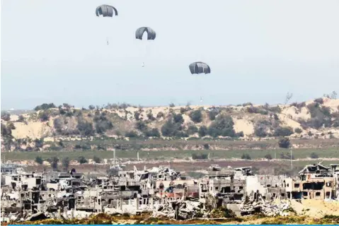  ?? ?? This photo shows an airdrop of humanitari­an aid over the besieged Palestinia­n territory on March 21, 2024. — AFP