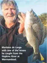  ??  ?? Martinus de Lange with one of the bream he caught from the Hopkins River at Warrnamboo­l.