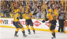  ?? FREDERICK BREEDON/GETTY IMAGES ?? Nashville Predators teammates Austin Watson, left, and Filip Forsberg congratula­te Calle Jarnkrok, right, on scoring against the St. Louis Blues on Sunday in Nashville, Tenn.