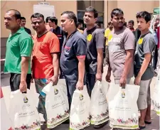  ??  ?? workers with their gift bags at the berkely men’s accommodat­ion.