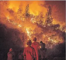  ?? NOAH BERGER THE ASSOCIATED PRESS ?? Firefighte­rs monitor a backfire while battling the Ranch Fire, part of the Mendocino Complex Fire, on Tuesday near Ladoga, Calif.