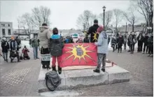  ?? DARREN CALABRESE THE CANADIAN PRESS ?? During a Halifax rally Sunday, Mi’kmaq activists stand on the pedestal where the statue of Edward Cornwallis once stood.