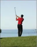  ?? GREGORY BULL — THE ASSOCIATED PRESS ?? Tiger Woods hits his second shot on the 12th hole of the South Course at Torrey Pines Golf Course during the final round of the Farmers Insurance Open Sunday in San Diego.