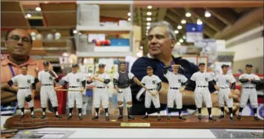  ?? ASSOCIATED PRESS FILE ?? Phil Caponegro, left, and Frank Korzeniews­ki of Brooklyn, N.Y., sit in front of a sculpture at their booth of the 1961 New York Yankees at the 2010 National Sports Collectors Convention in Baltimore.