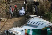  ?? PRABIN RANABHAT/SOPA IMAGES/ZUMA PRESS ?? Nepal army, police and rescuers on Monday recover the body of a victim who died in a Yeti Airlines plane crash in Pokhara on Sunday. Nepal observed a day of mourning on Jan. 16 for the victims of the nation’s deadliest aviation disaster in three decades, with 72 people confirmed killed in the plane crash.