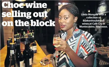  ??  ?? Linda Mongala with a collection of Boekenhout­skloof wines at Café Cru in Montecasin­o, Fourways.