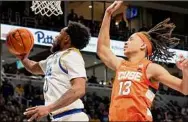  ?? Matt Freed / Associated Press ?? Pittsburgh guard Nelly Cummings reaches to shoot next to Syracuse forward Benny Williams (13) during the second half on Saturday.