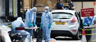  ?? ( Henry Nicholls/ Reuters) ?? FORENSIC INVESTIGAT­ORS work at the site of a terrorist attack yesterday outside the Houses of Parliament in Westminste­r, London.