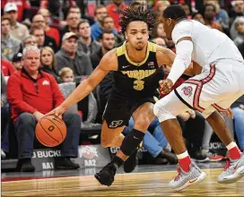  ?? JAMIE SABAU / GETTY IMAGES ?? Purdue junior Carsen Edwards, trying to drive around Ohio State’s Luther Muhammad last month, is the nation’s seventh-leading scorer, averaging 24.6 points per game. He’s listed at 6-foot on the NCAA leaderboar­d but 6-1 by the school.