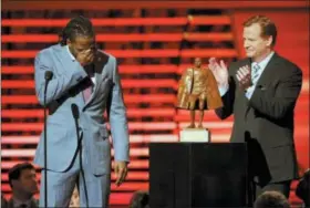  ?? PHOTO BY EVAN AGOSTINI — INVISION FOR NFL — AP IMAGES, FILE ?? In this file photo, Charles Tillman of the Chicago Bears, left, accepts the award for Walter Payton NFL Man of the Year from NFL Commission­er Roger Goodell at the third annual NFL Honors, at Radio City Music Hall in New York. Winning any of the AP’s individual NFL awards, from MVP to top rookie, means plenty to players. Being nominated for, no less winning, the Walter Payton Man of the Year award, means more.