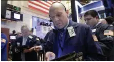  ?? RICHARD DREW — THE ASSOCIATED PRESS ?? Trader Daniel Leporin, foreground, works on the floor of the New York Stock Exchange, Wednesday.